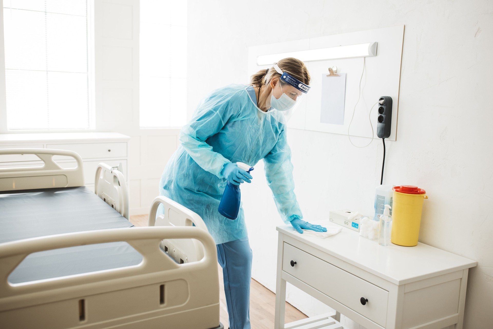 Nurse cleaning hospital ward.