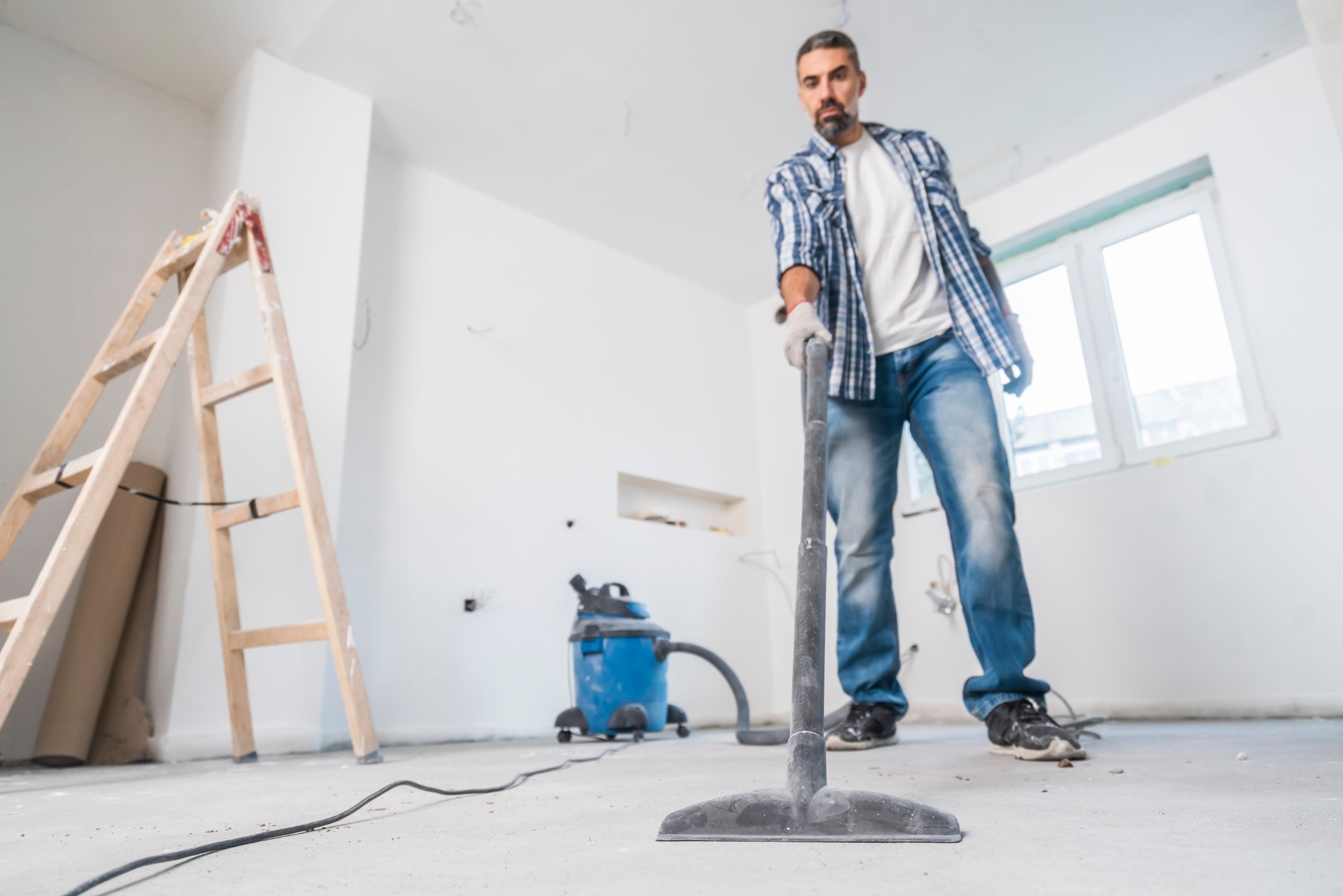 Construction Worker  Vacuuming On a Construction Site